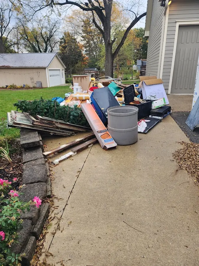 Dumpster being loaded with debris for Roofing Dumpster Rental in Woodburn